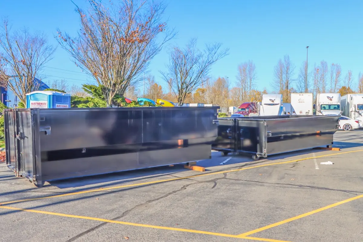 Professional dumpster rental service with roll-off container on residential driveway in Lake Magdalene